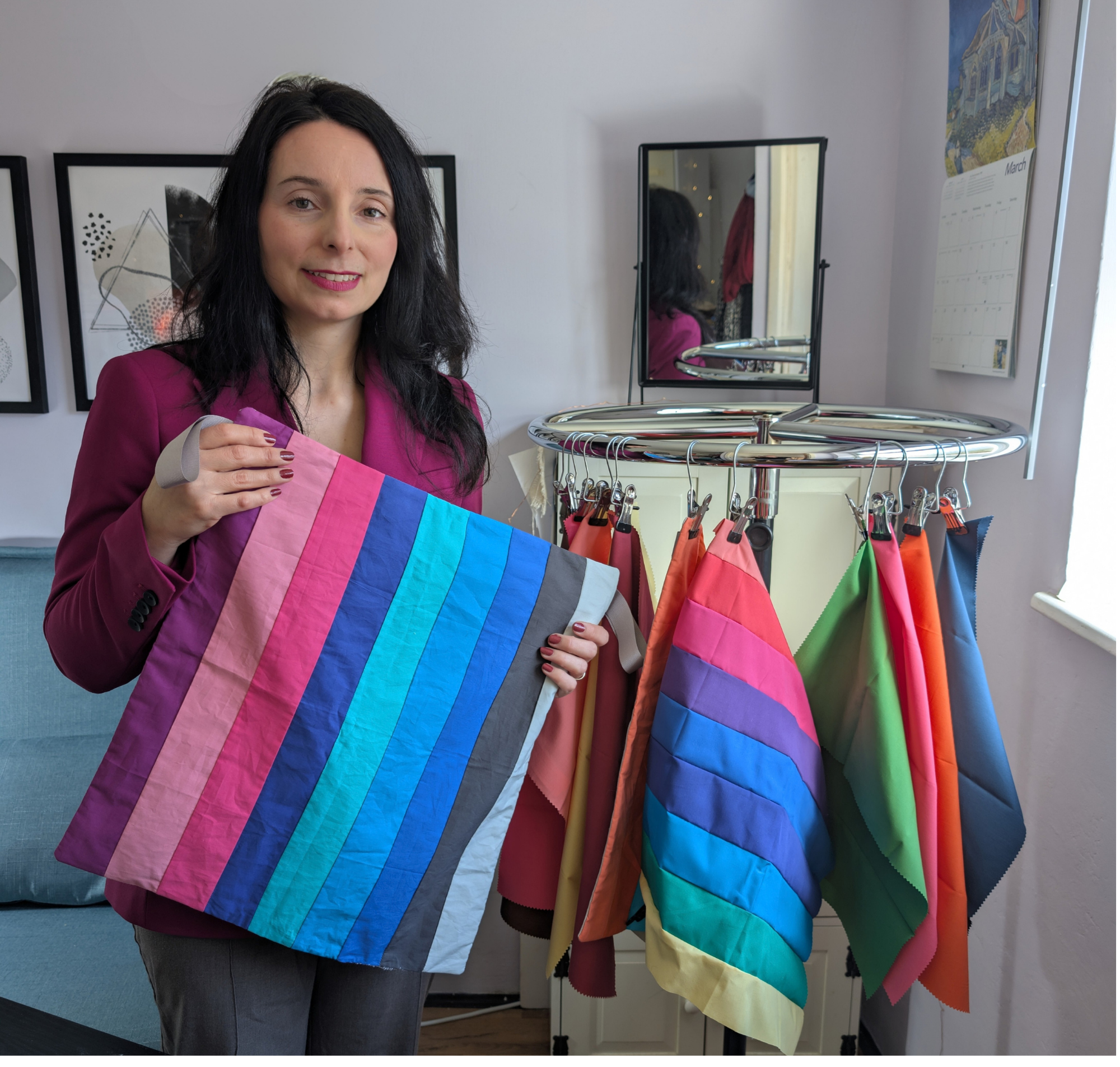 Maria Curley, personal colour analyst in Oxfordshire, holding colour drapes in her studio